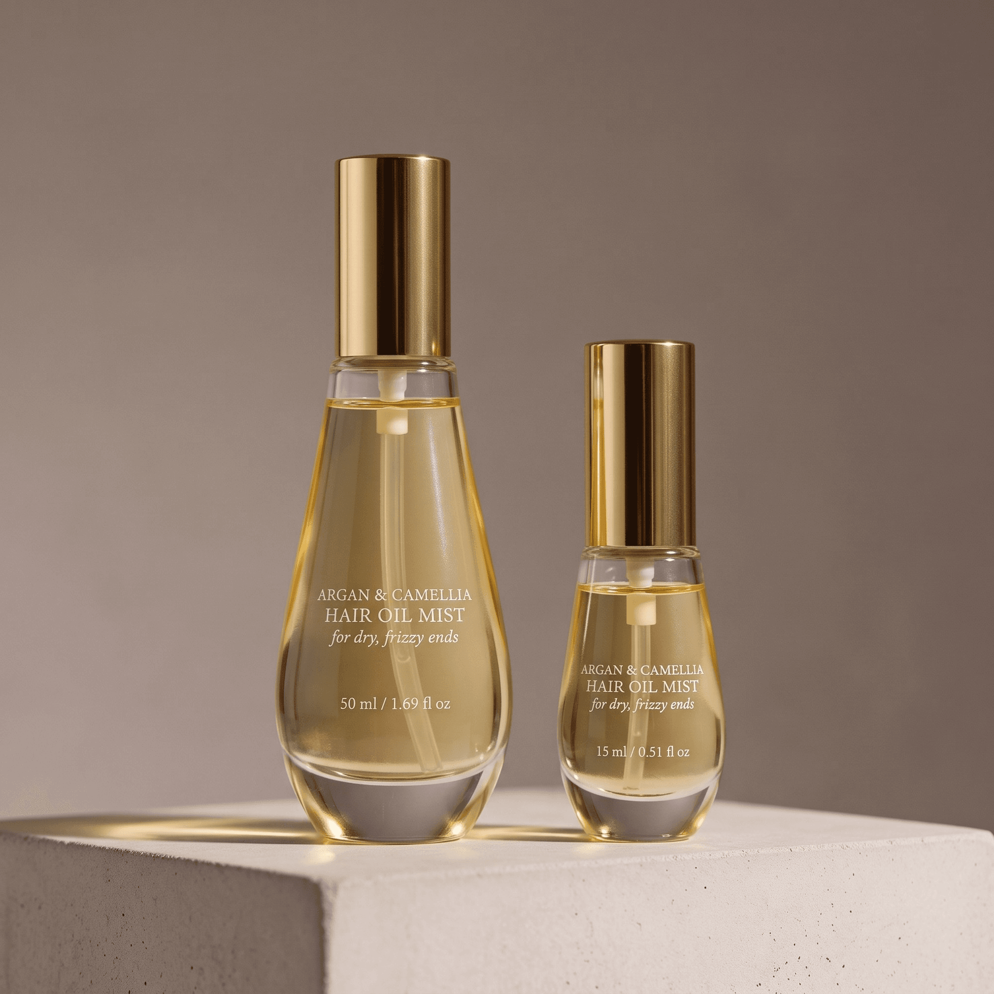 Amazon A+ comparison image example: a 50 ml teardrop-shaped glass bottle with a gold spray cap standing beside a smaller 15 ml travel bottle of the same design on a pale stone block, both lit the same way against a warm gray wall