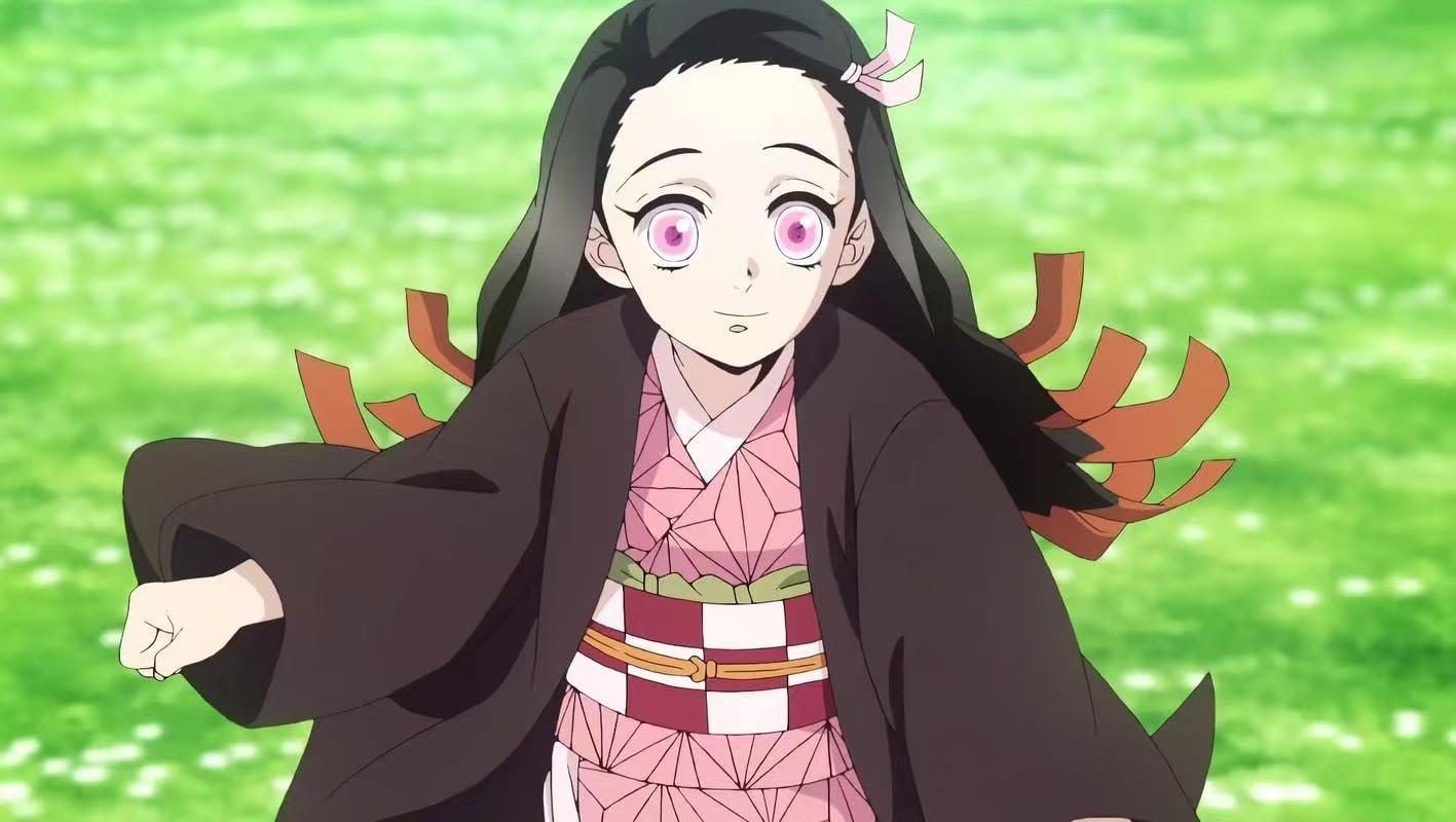 Nezuko Kamado smiling and running through a bright green field