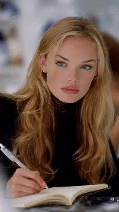 Looping GIF made in ChatGPT from one portrait photo: a blonde woman writing in a notebook looks down at the page, writes, then lifts her eyes back to the camera and settles into the original pose