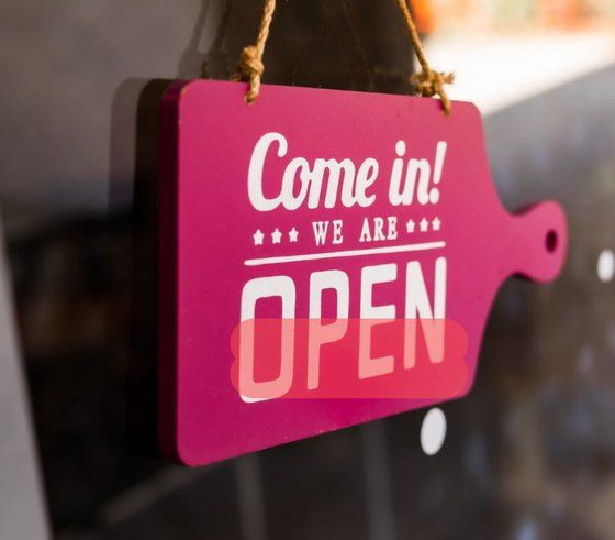 The pink Open sign loaded into the eraser canvas with a translucent red brush stroke covering the word OPEN