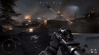 First-person view of a rifle aimed at a burning military base