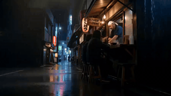 Chef preparing food for customers at a rainy night food stall