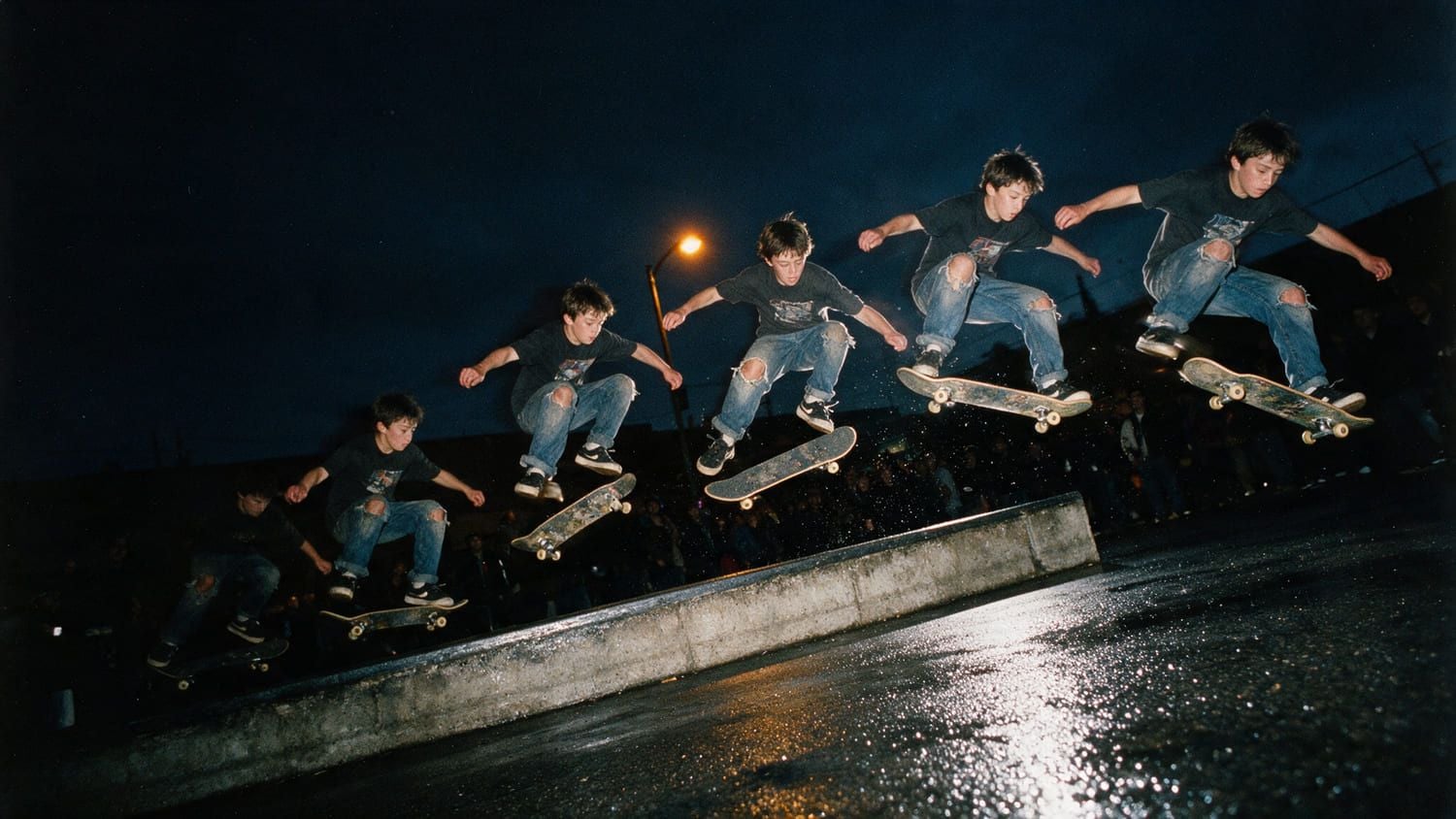 Sequence of a skateboarder jumping over a concrete ledge at night