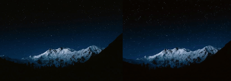 Snowy mountain peaks under a starry night sky