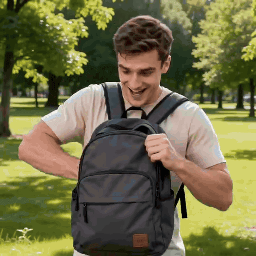 Excited young man looking inside a black backpack in a park