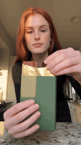 Atlas Cloud AI UGC ad generated from the test kit: the presenter shows the chocolate bar, snaps off a square with caramel inside, and tastes it while speaking the three scripted lines.