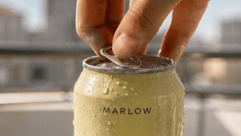 Highlights from the Brief A commercial made with TVC Maker: a pale-yellow Marlow Yuzu can cracks open with fizz, a woman with short dark hair sips it on a sunny balcony, a yuzu half is squeezed over a glass, and the spot ends on a packshot with the text MARLOW YUZU