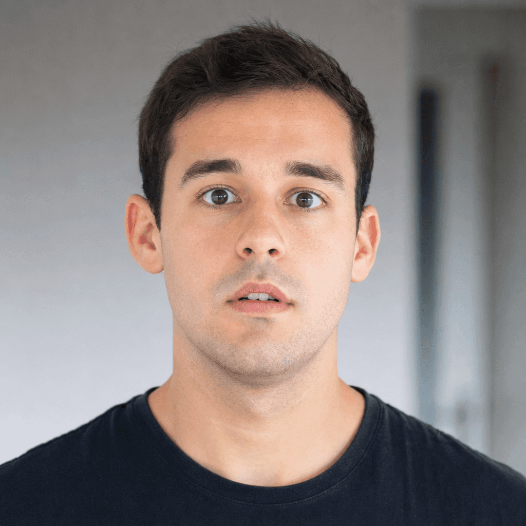 Surprised young man with wide eyes and slightly open mouth